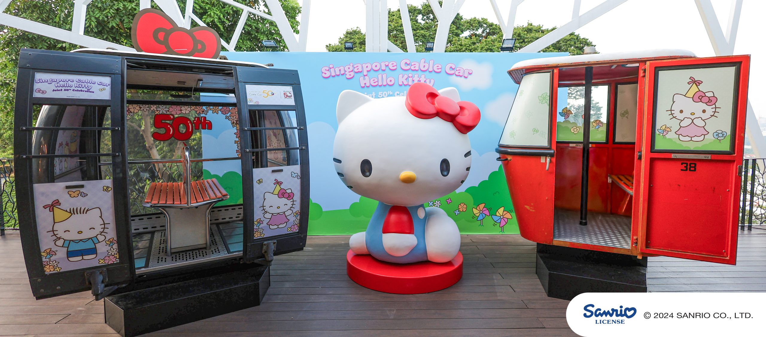 Image Hello Kitty sculpture in signature red bow and blue overalls scaled