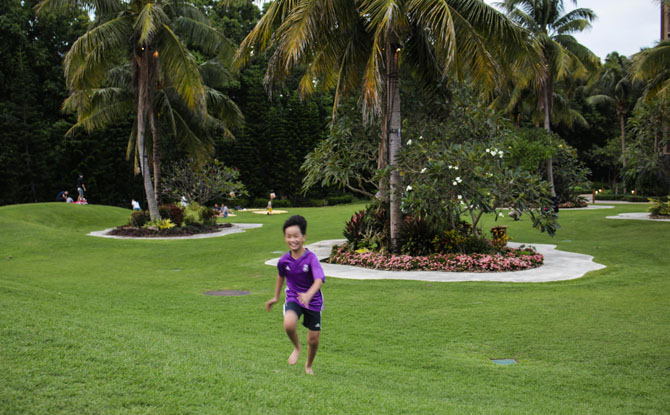 boy running green field psle