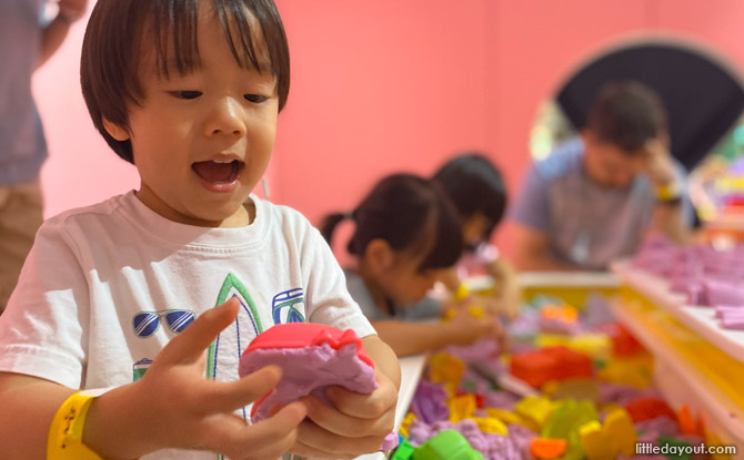 Activity tables are filled with kinetic sand and colourful building blocks